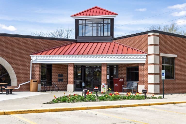 Library entrance with sheltered overhang and brick columns